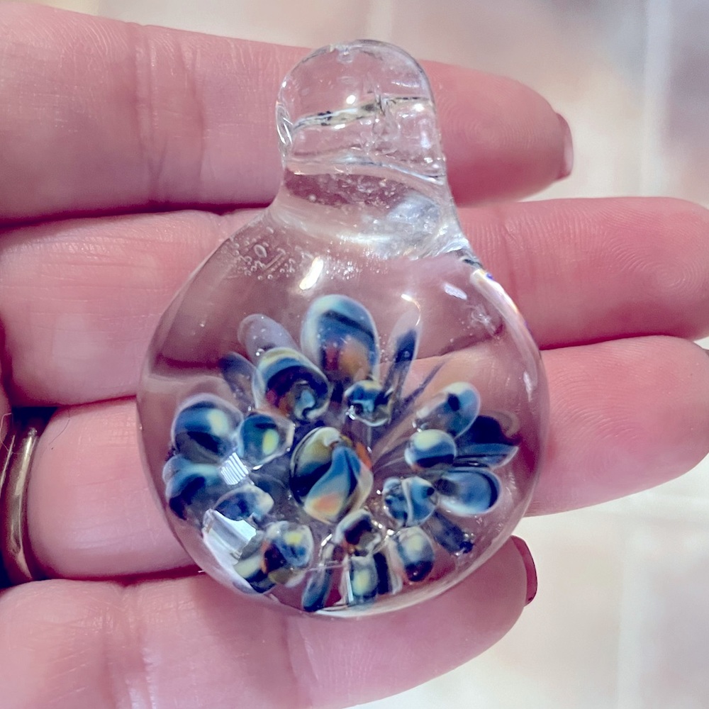 Clear blown glass pendant or charm with color burst